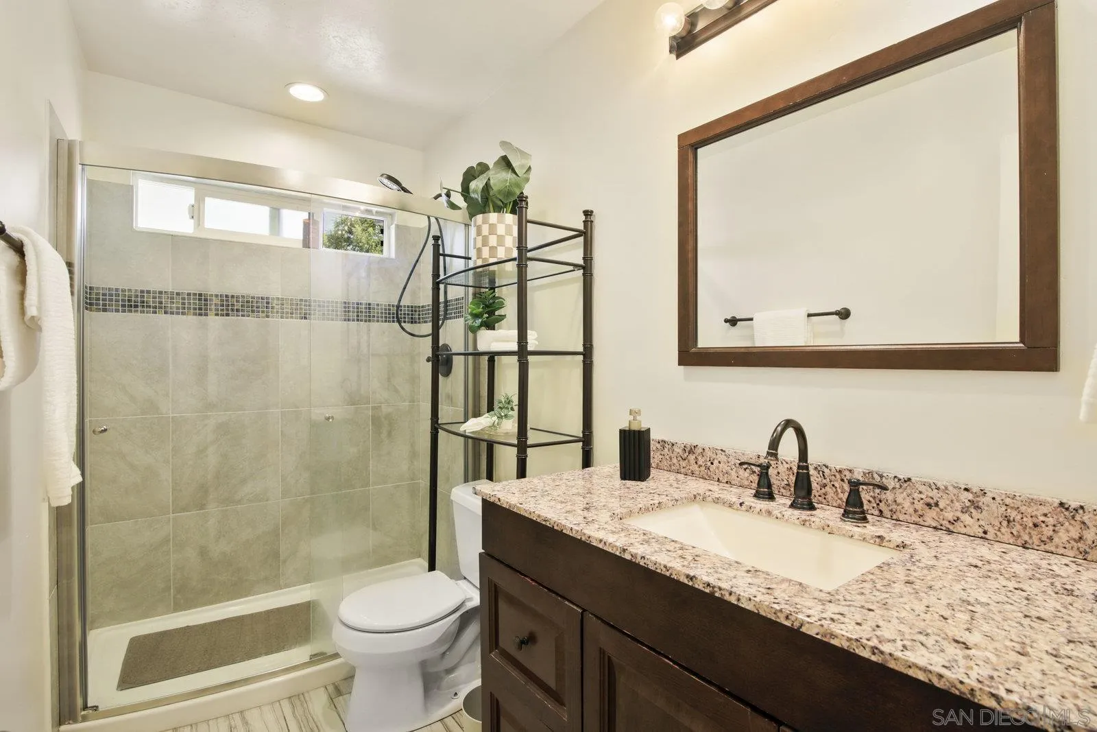 10442 Nate Way Santee, CA 92071 - Photo 13 of 31 a bathroom with a granite countertop sink toilet and shower