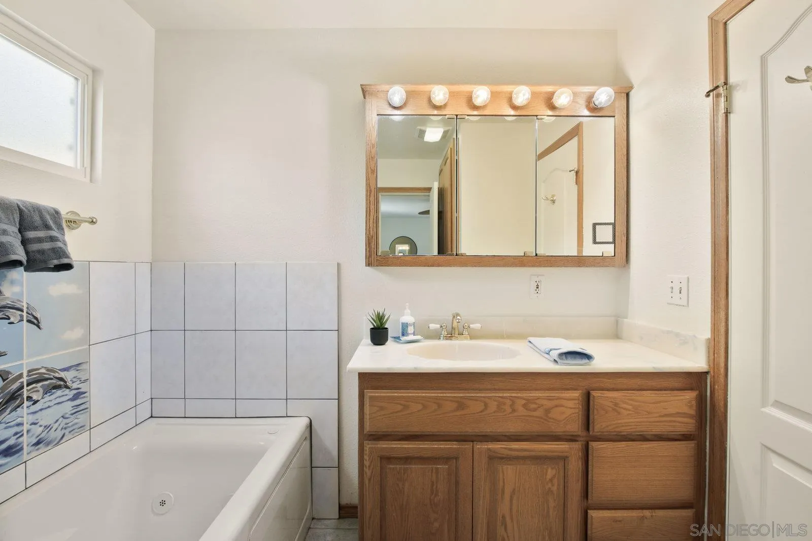 10442 Nate Way Santee, CA 92071 - Photo 16 of 31 a bathroom with a sink a vanity and a bathtub