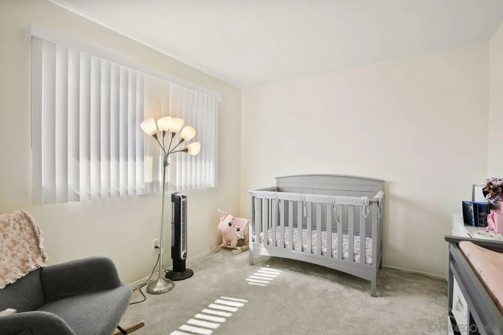 10442 Nate Way Santee, CA 92071 - Photo 18 of 31 a bedroom with a baby bed a couch and a baby crib