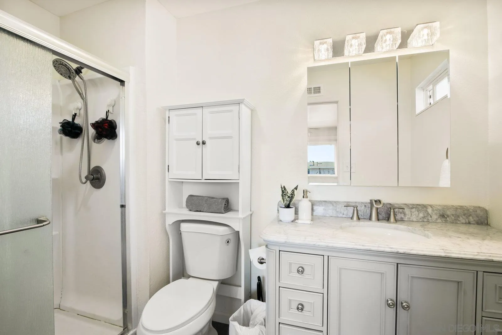 10442 Nate Way Santee, CA 92071 - Photo 21 of 31 a bathroom with a granite countertop toilet sink and shower