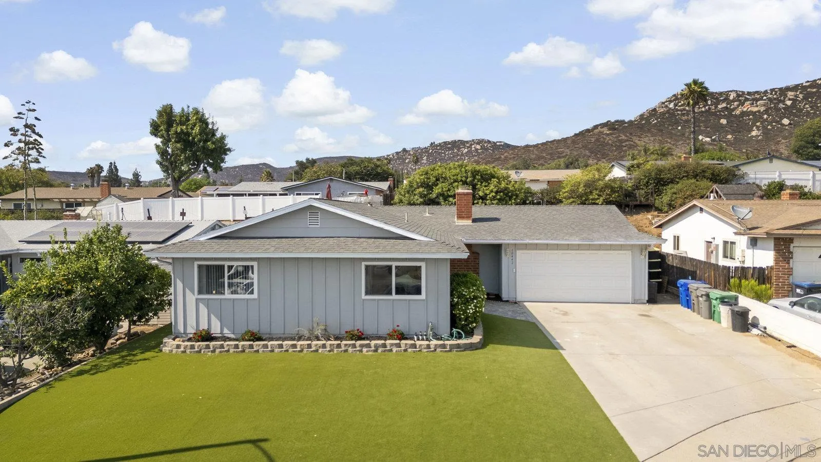 10442 Nate Way Santee, CA 92071 - Photo 27 of 31 a front view of a house with a garden and yard