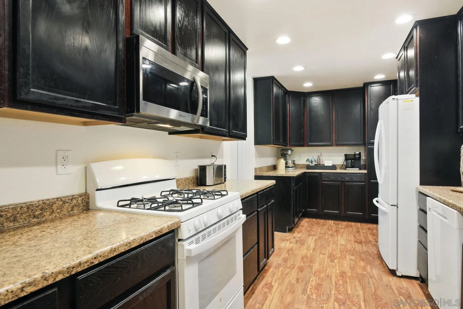 10442 Nate Way Santee, CA 92071 - Photo 5 of 31 a kitchen with stainless steel appliances kitchen island granite countertop a sink stove and refrigerator