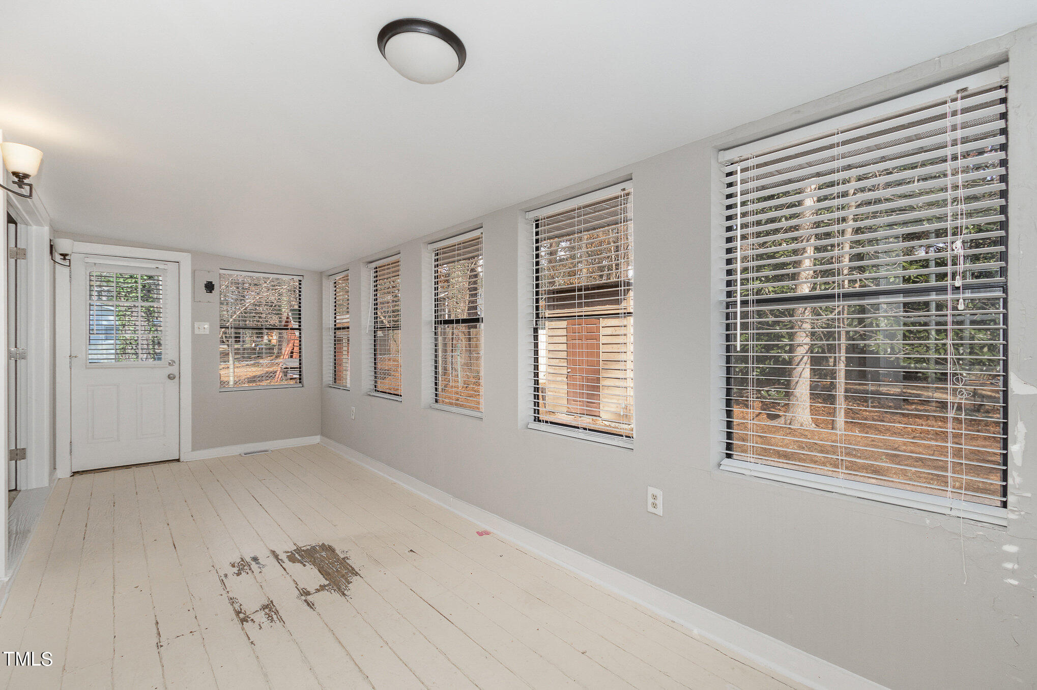 6309 Garrett Road Durham, NC 27707 - Photo 14 of 17 a view of an empty room with a window and wooden floor