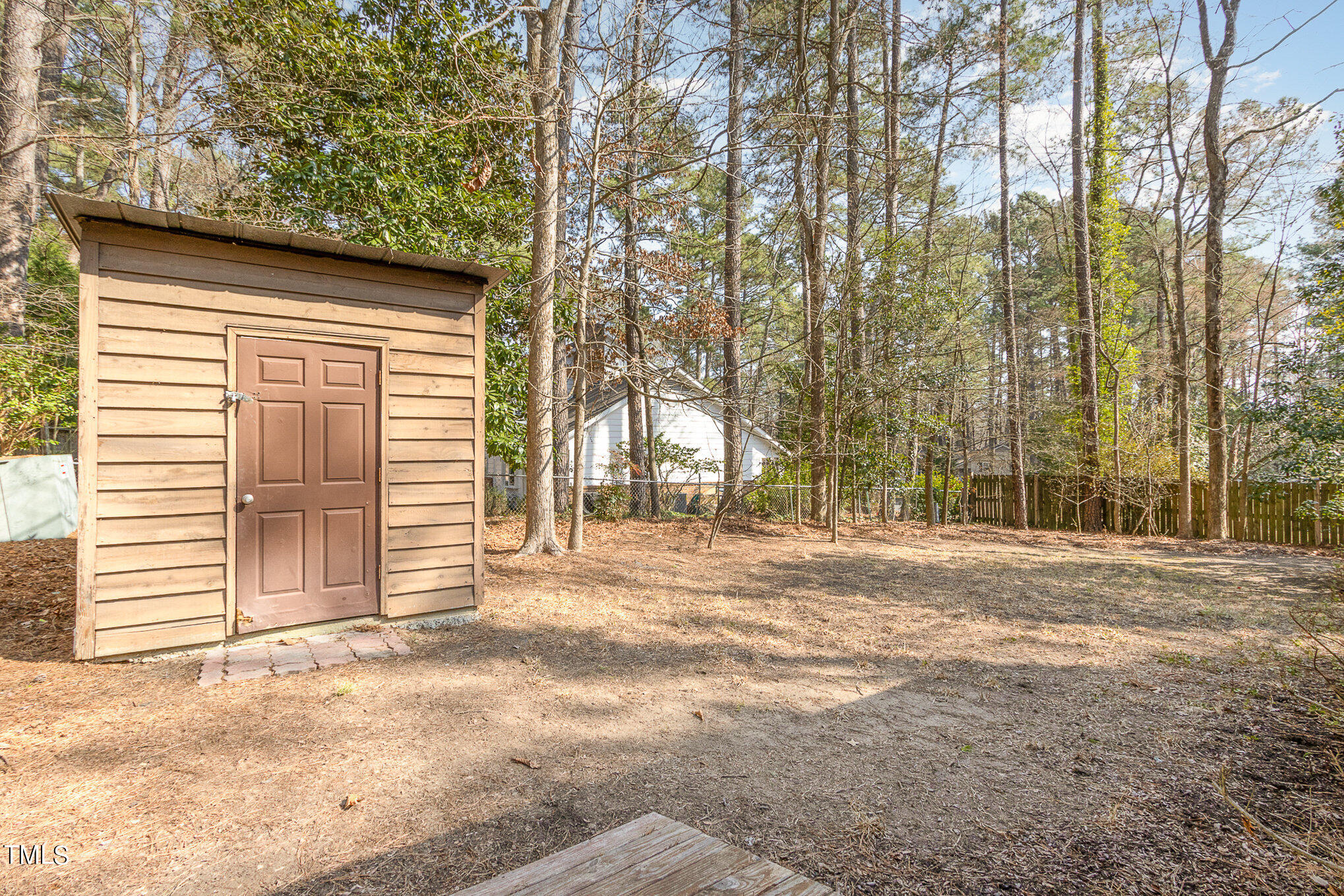 6309 Garrett Road Durham, NC 27707 - Photo 15 of 17 a view of a house with a backyard and trees