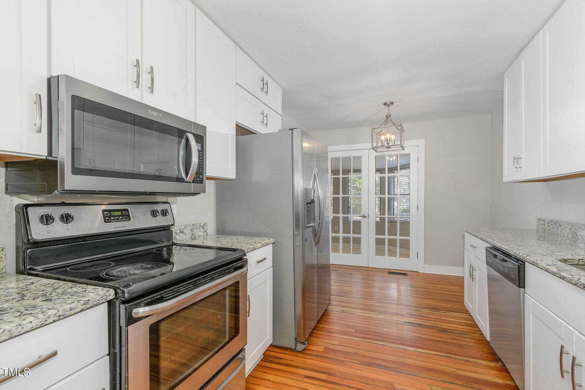 6309 Garrett Road Durham, NC 27707 - Photo 4 of 17 a kitchen with a stove and a microwave