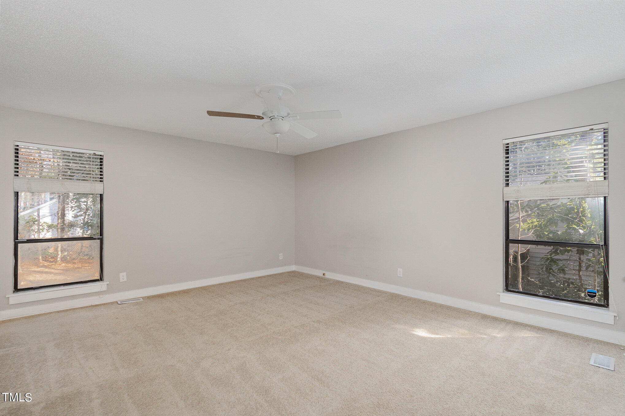 6309 Garrett Road Durham, NC 27707 - Photo 7 of 17 an empty room with windows and closet