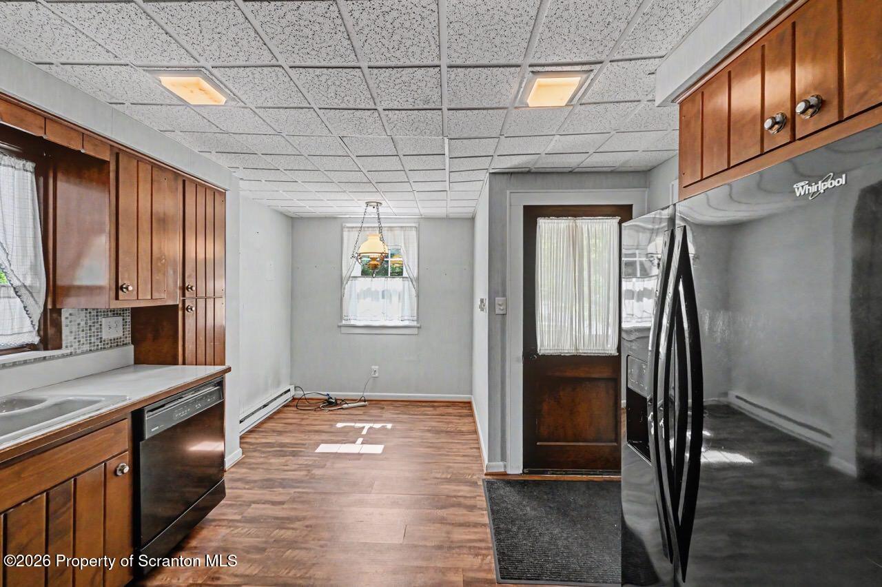 502 Layton Road Clarks Summit, PA 18411 - Photo 17 of 42 a view of a hallway with wooden floor and a kitchen