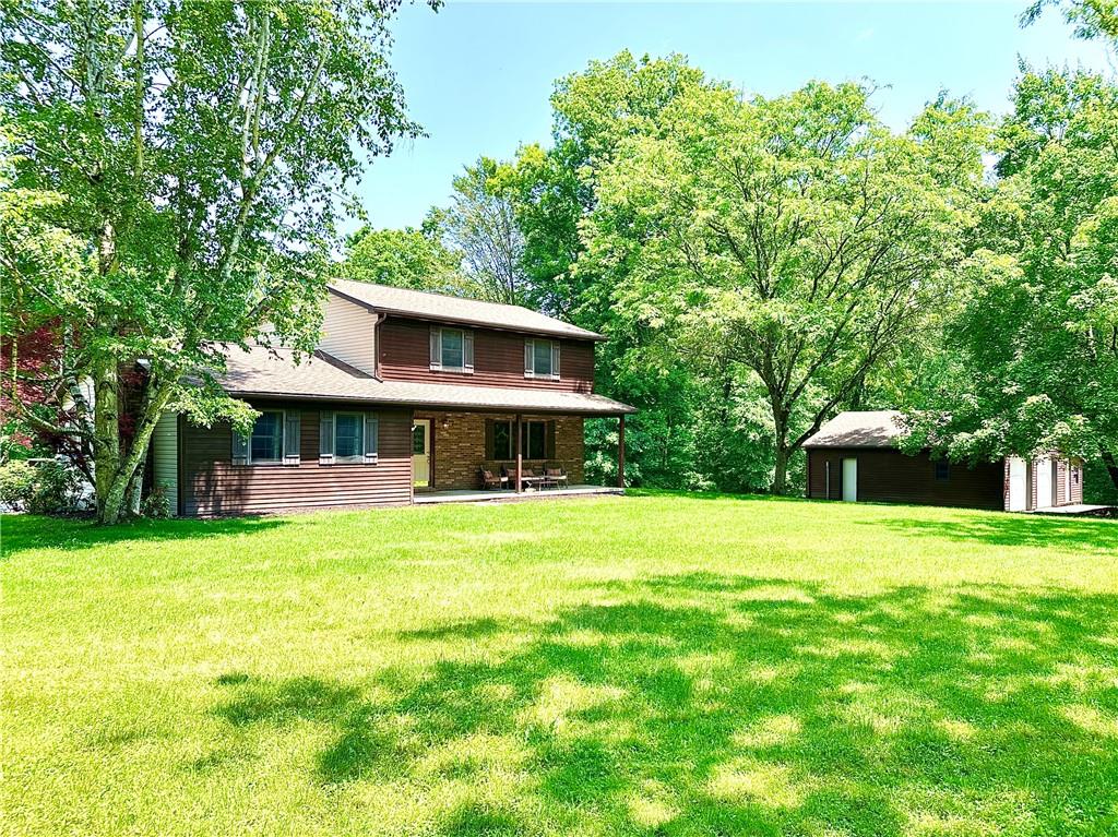 752 Covered Bridge Road Volant, PA 16156 - Photo 1 of 48 a front view of a house with garden