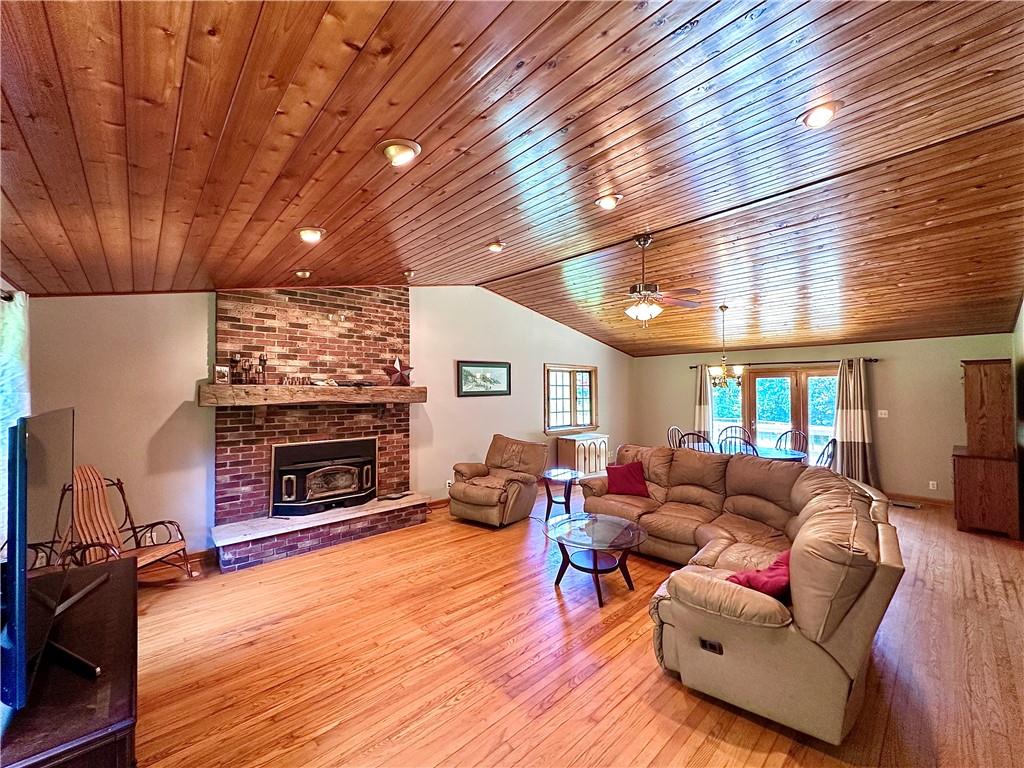 752 Covered Bridge Road Volant, PA 16156 - Photo 11 of 48 a living room with furniture a fireplace and a wooden floor
