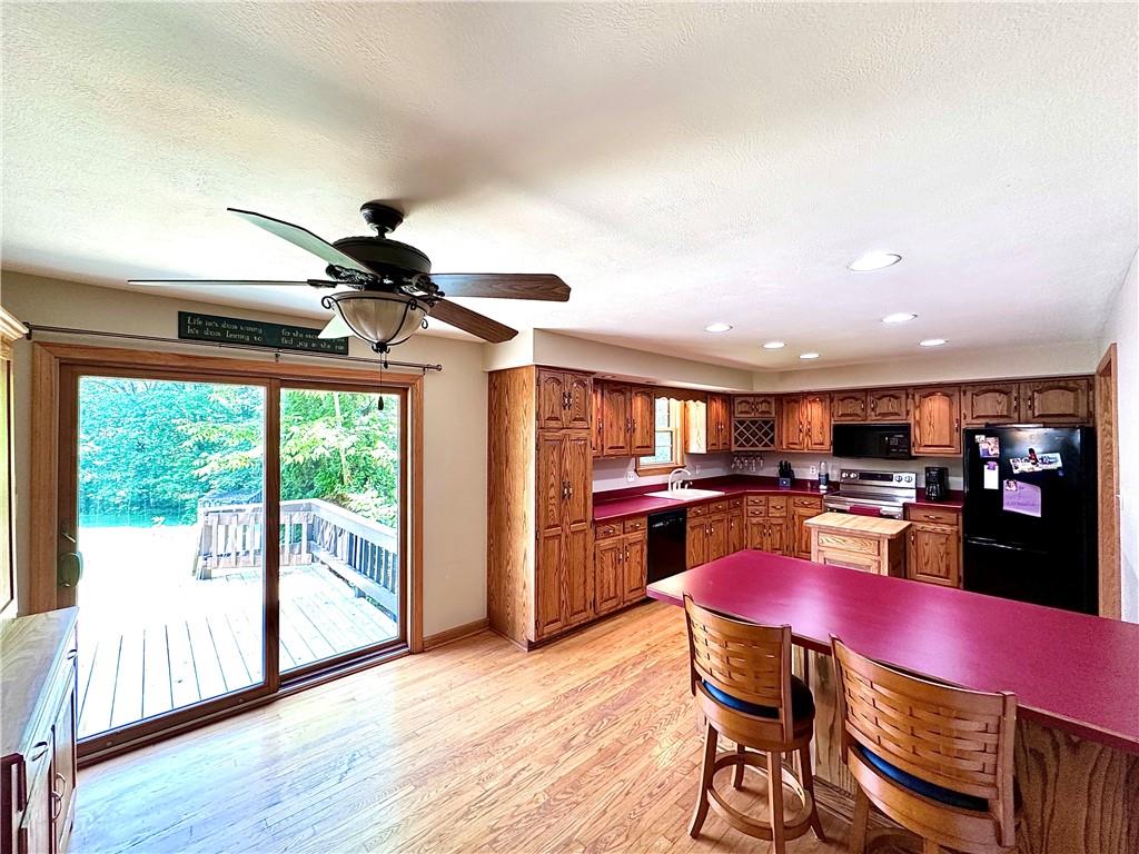 752 Covered Bridge Road Volant, PA 16156 - Photo 16 of 48 a view of a dining room with furniture window and wooden floor