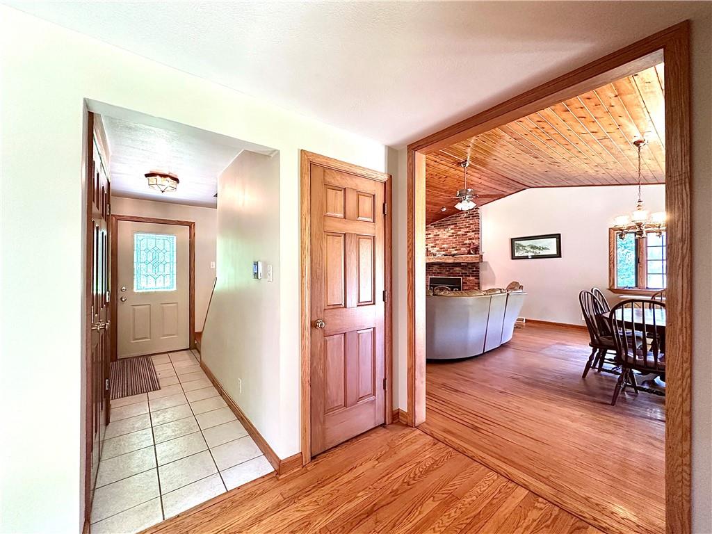 752 Covered Bridge Road Volant, PA 16156 - Photo 20 of 48 a view of a livingroom and a dining room with furniture wooden floor a chandelier