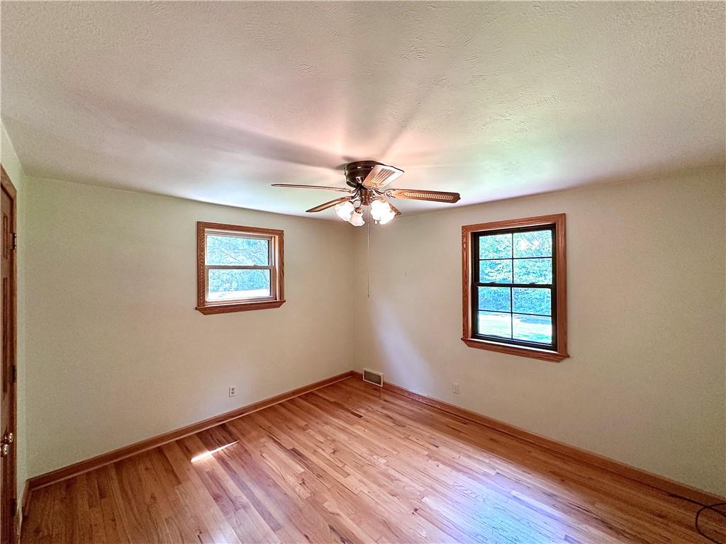 752 Covered Bridge Road Volant, PA 16156 - Photo 25 of 48 wooden floor in an empty room with a window