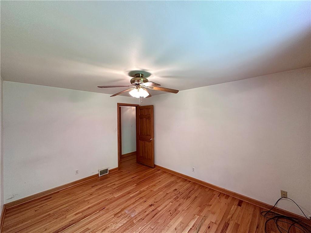 752 Covered Bridge Road Volant, PA 16156 - Photo 26 of 48 a view of an empty room with wooden floor