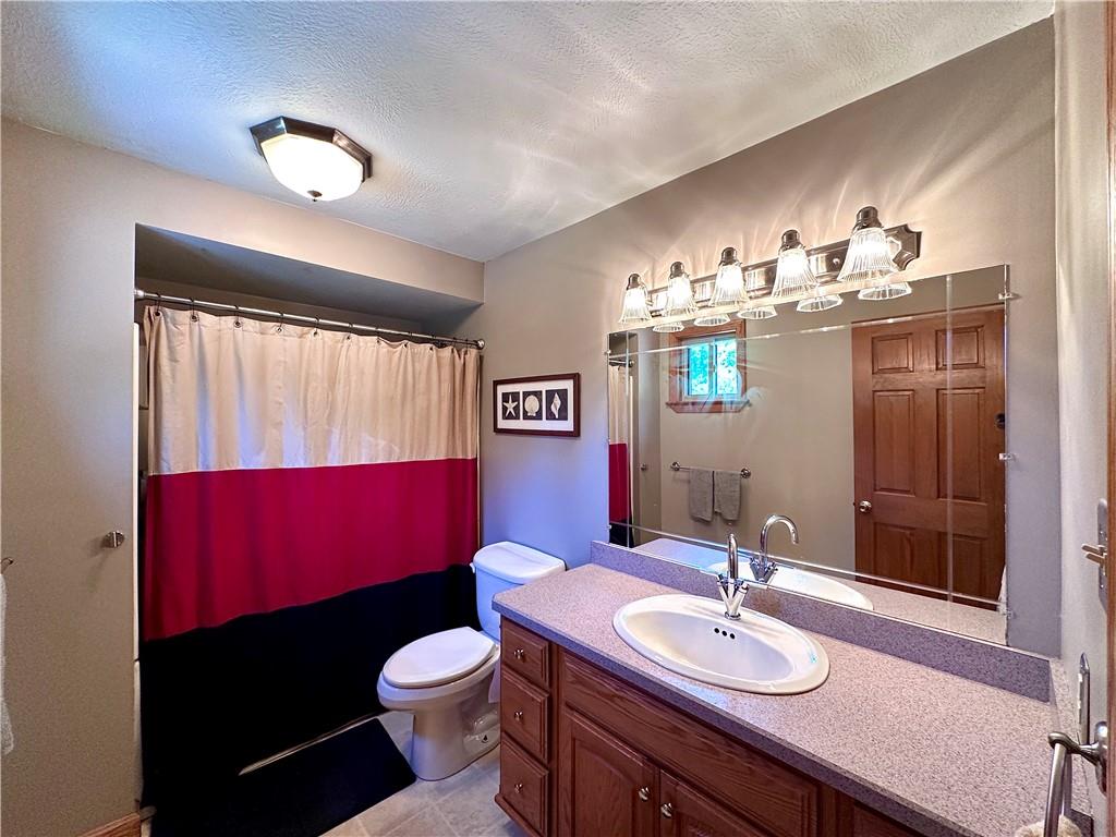 752 Covered Bridge Road Volant, PA 16156 - Photo 27 of 48 a bathroom with a sink a toilet and mirror