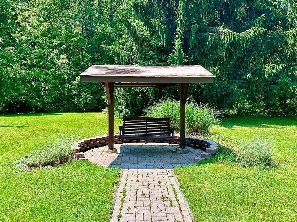 752 Covered Bridge Road Volant, PA 16156 - Photo 39 of 48 a view of swimming pool with a table and chairs under an umbrella