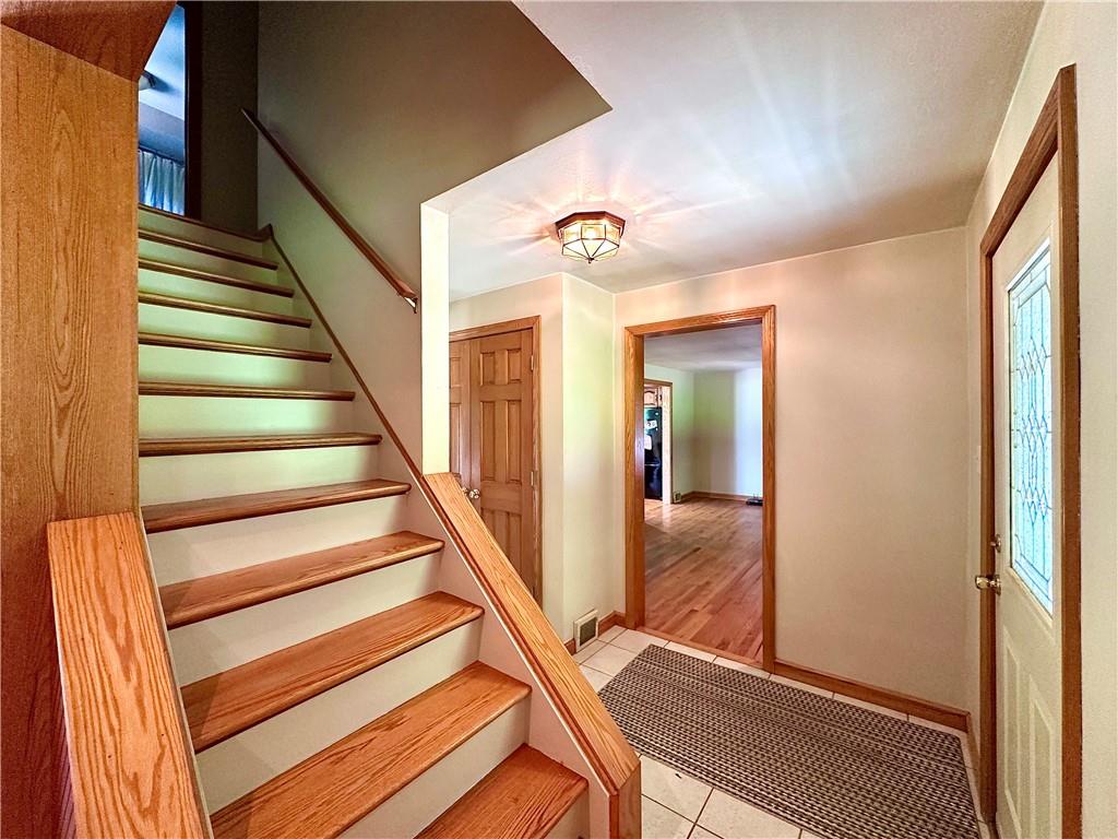 752 Covered Bridge Road Volant, PA 16156 - Photo 8 of 48 a view of a hallway with wooden floor and staircase