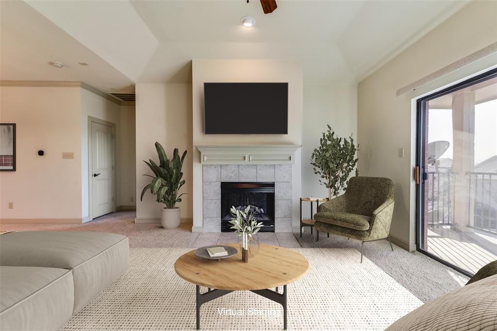 a living room with furniture a flat screen tv and a fireplace