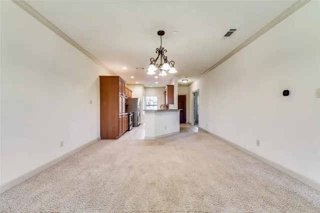 a view of a kitchen with a sink and a chandelier