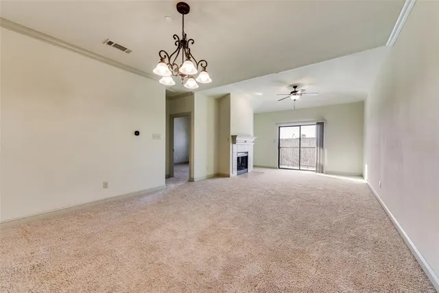 a view of a chandelier in big room and chandelier