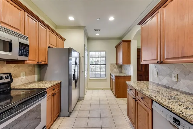 a kitchen with a refrigerator stove top oven and sink