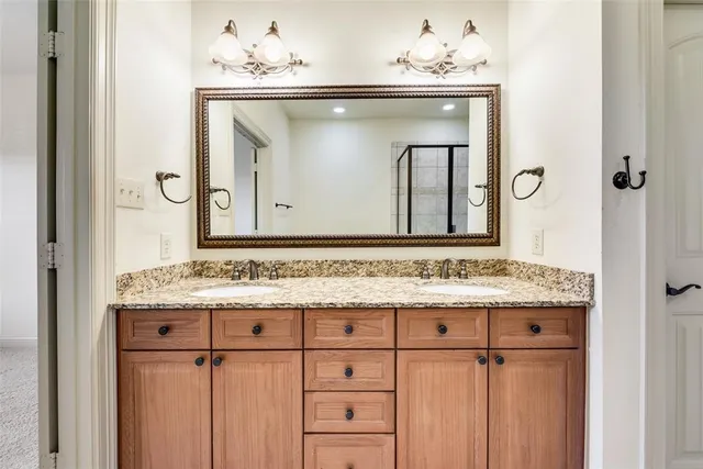 a bathroom with a sink vanity and a mirror