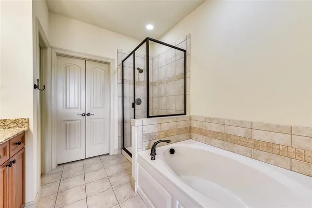 a bathroom with a bathtub and shower