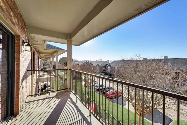 a view of a balcony with wooden floor and fence