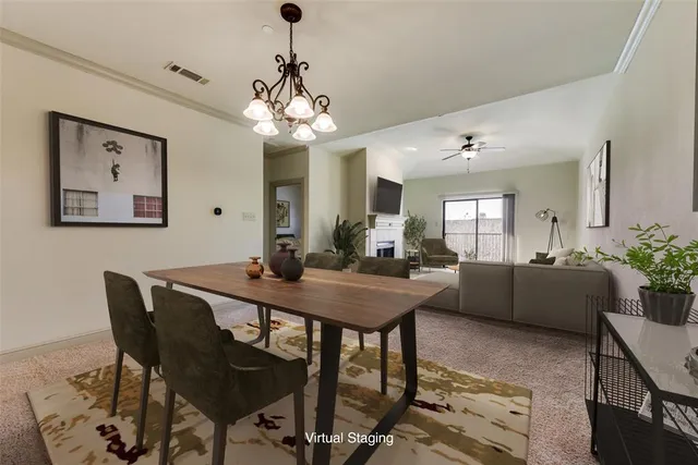 a view of a dining room with furniture and chandelier