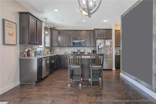 a kitchen with a table and chairs in it