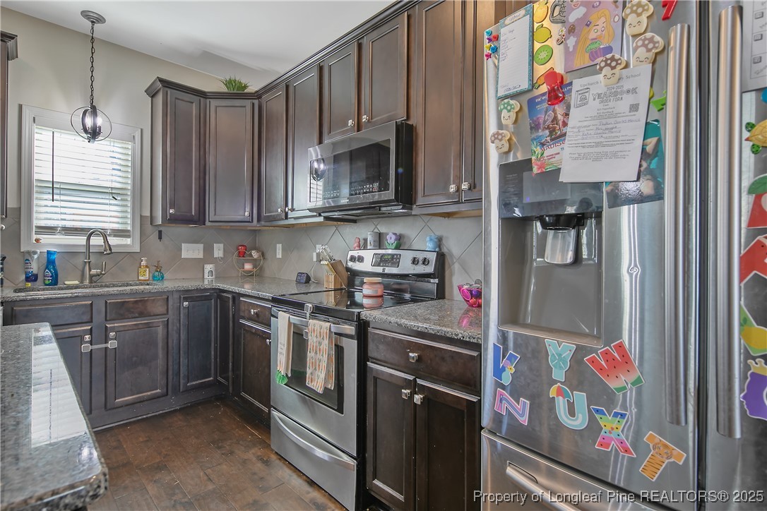 688 Stonebriar Avenue Raeford, NC 28376 - Photo 15 of 50 a kitchen with stainless steel appliances granite countertop a refrigerator and a sink