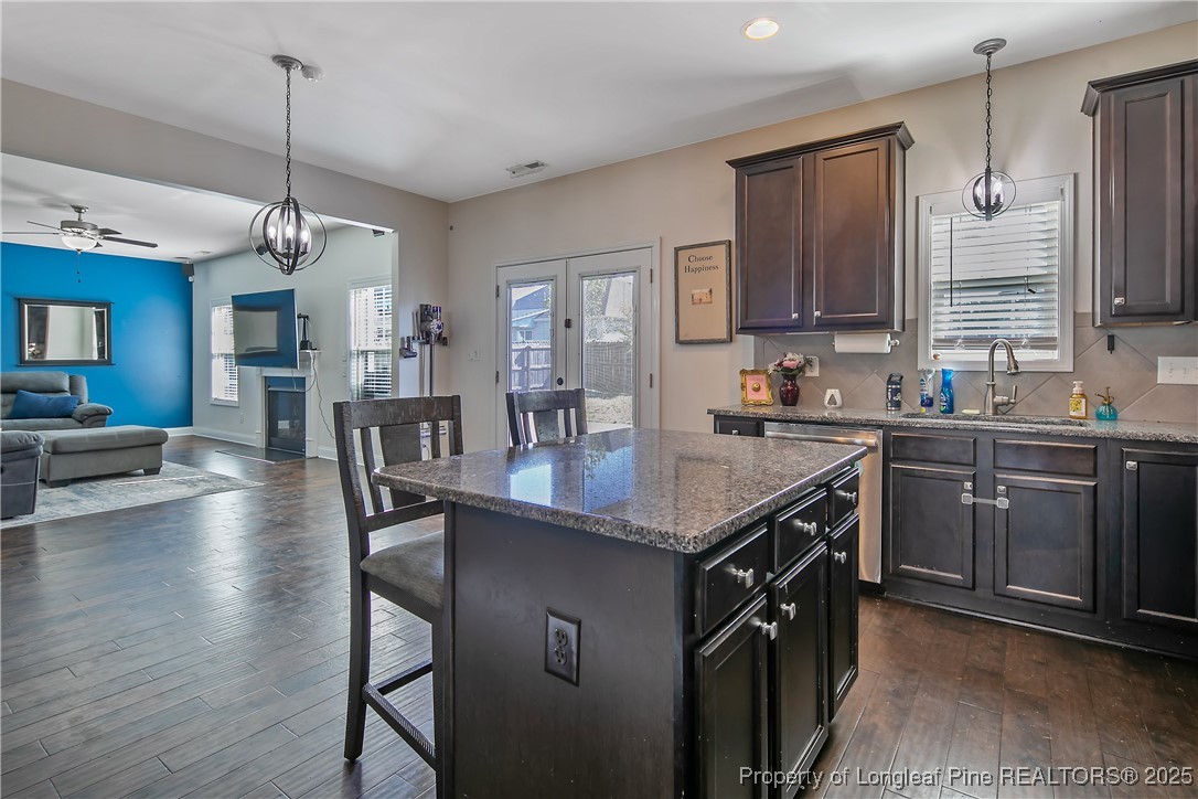 688 Stonebriar Avenue Raeford, NC 28376 - Photo 17 of 50 a kitchen with sink cabinets and wooden floor