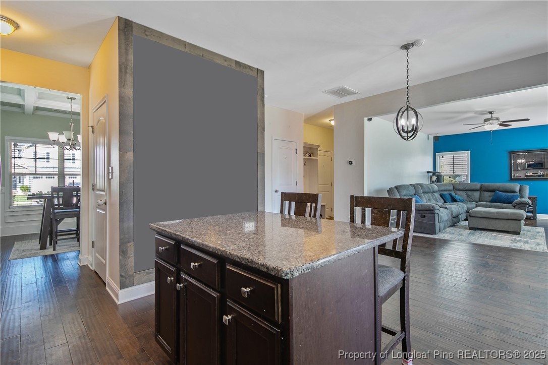 688 Stonebriar Avenue Raeford, NC 28376 - Photo 18 of 50 a kitchen with a table chairs and wooden floor