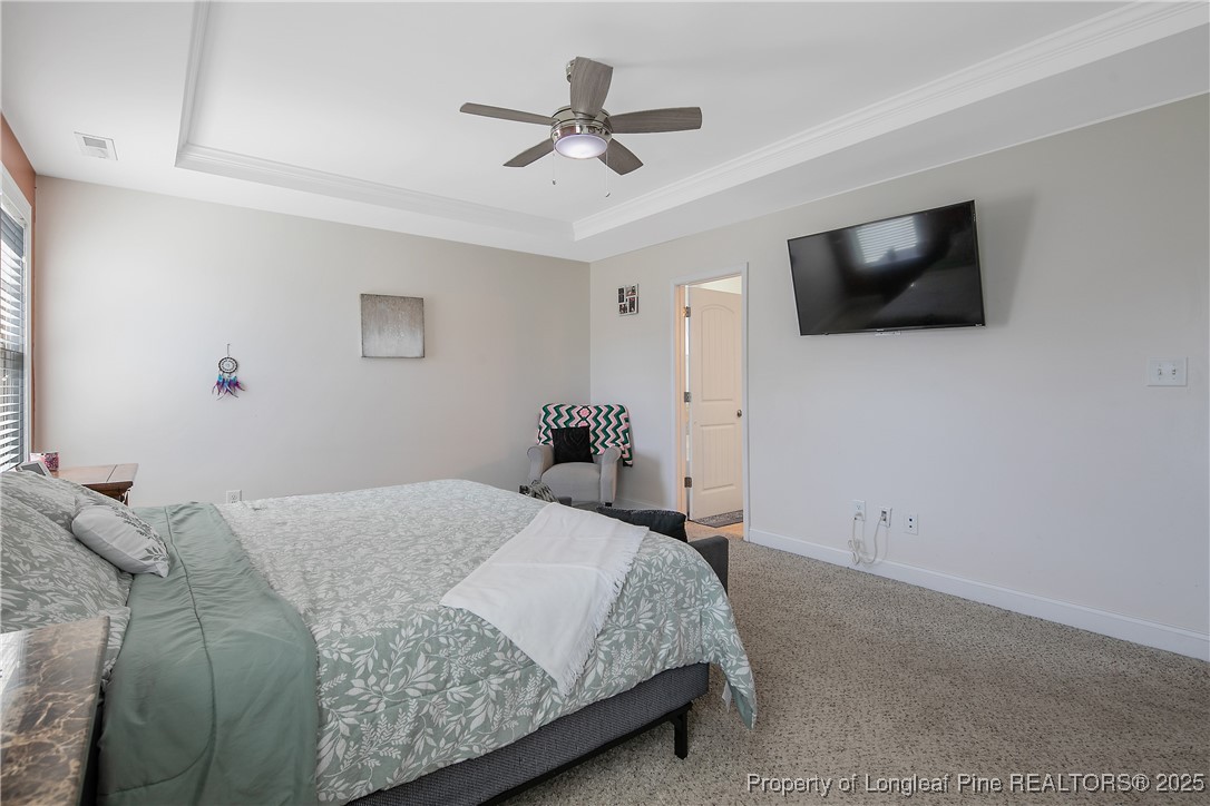 688 Stonebriar Avenue Raeford, NC 28376 - Photo 23 of 50 a bedroom with a large bed and a flat screen tv