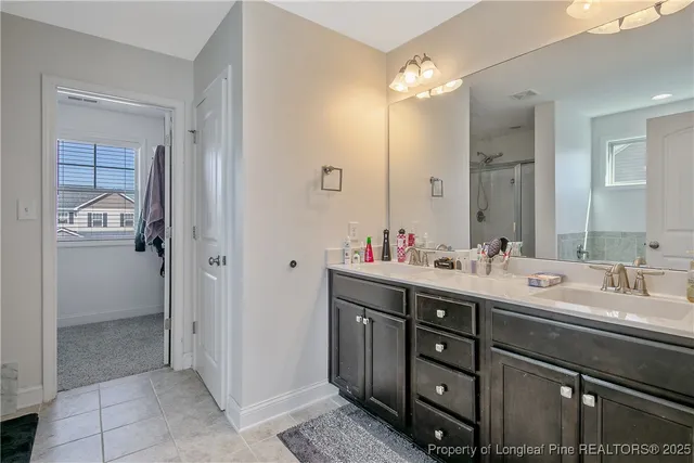 a bathroom with a double vanity sink and a mirror