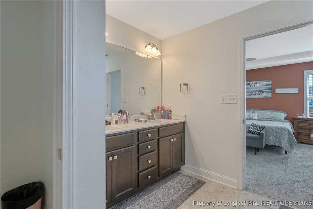 688 Stonebriar Avenue Raeford, NC 28376 - Photo 27 of 50 a bathroom with a double vanity sink and a mirror