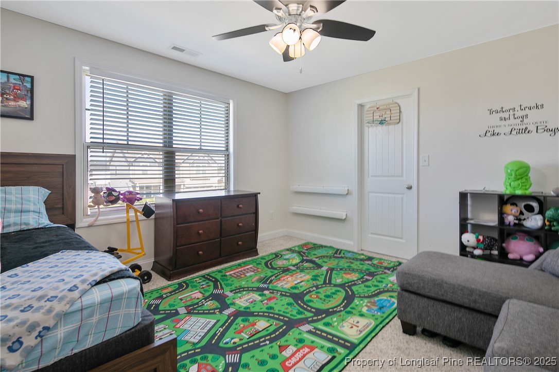 688 Stonebriar Avenue Raeford, NC 28376 - Photo 31 of 50 a bedroom with a bed and a chandelier