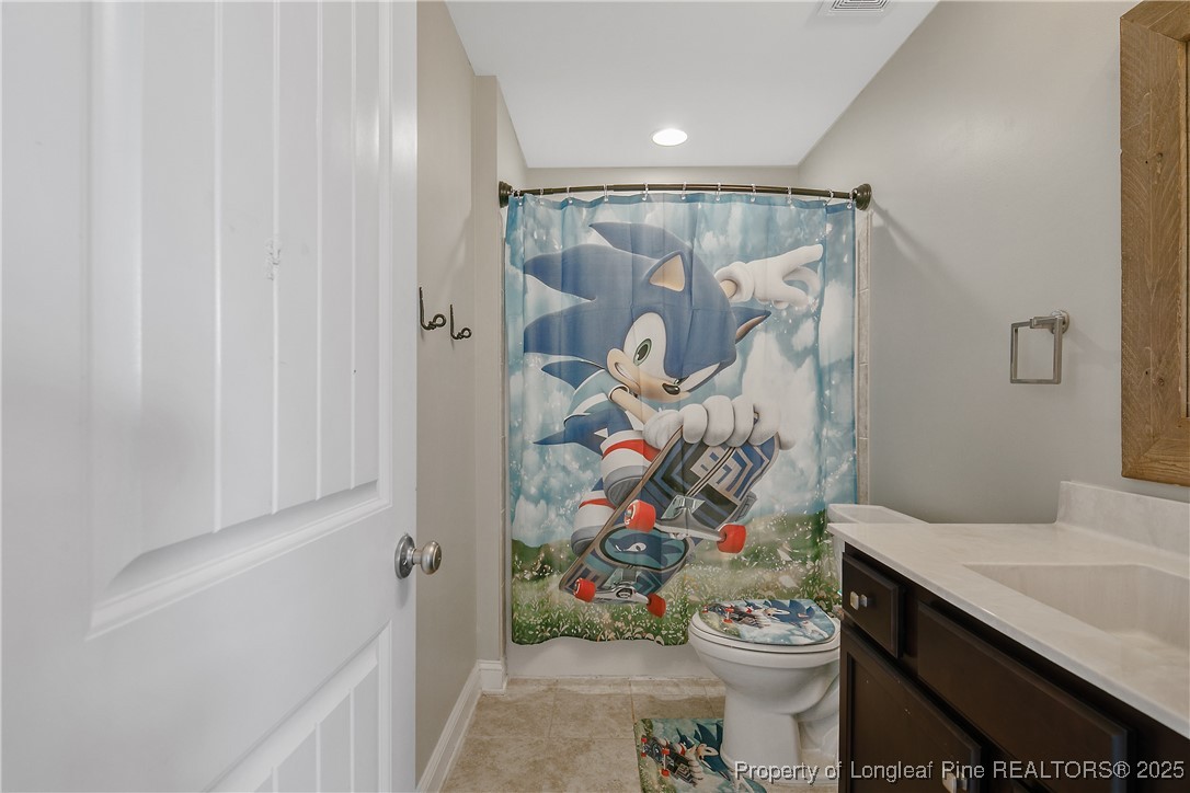688 Stonebriar Avenue Raeford, NC 28376 - Photo 40 of 50 a bathroom with a sink mirror vanity and toilet