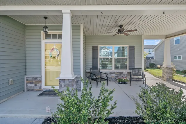 a front view of a house with outdoor seating and plants