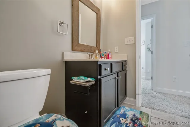 a bathroom with a sink toilet and mirror