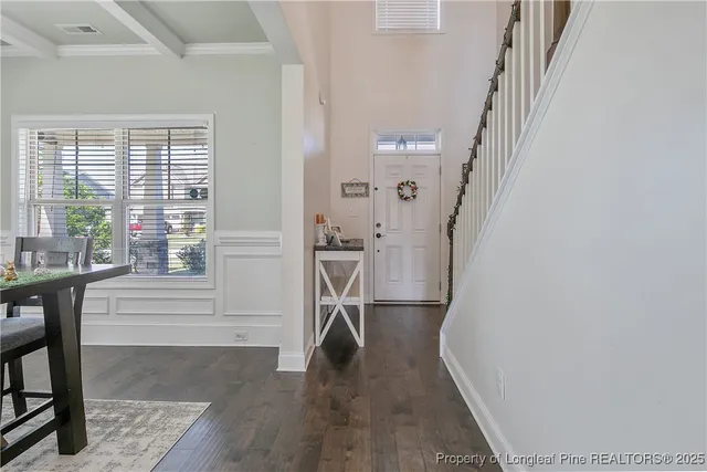 a view of entryway with furniture and wooden floor