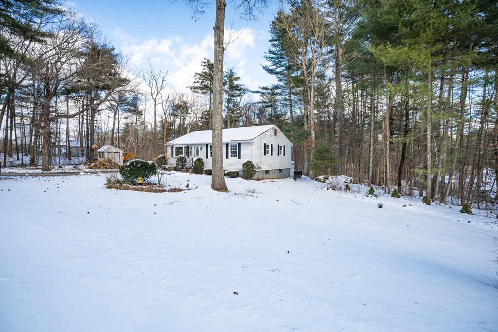 246 Bumstead Road Monson, MA 01057 - Photo 3 of 32 a view of a white house with a yard covered in snow