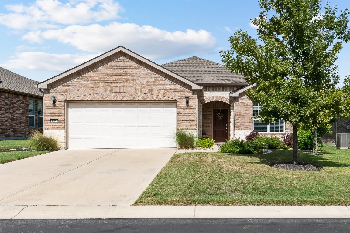 a front view of house with garage and yard
