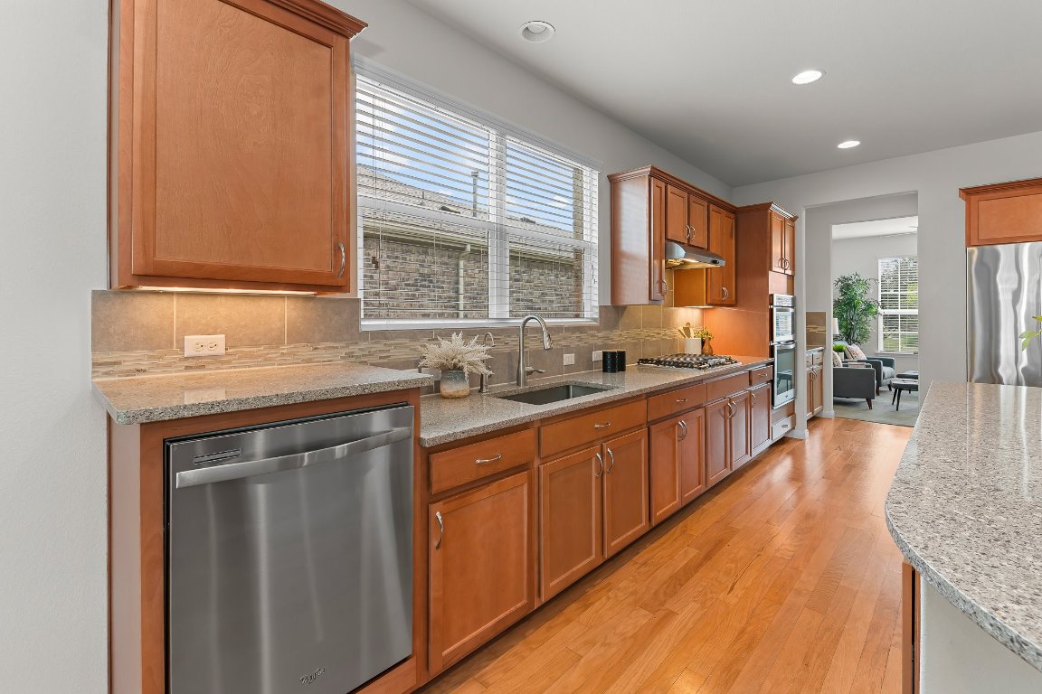 608 Kite Ridge Street Georgetown, TX 78633 - Photo 18 of 39 a large kitchen with stainless steel appliances granite countertop a lot of counter space and a sink