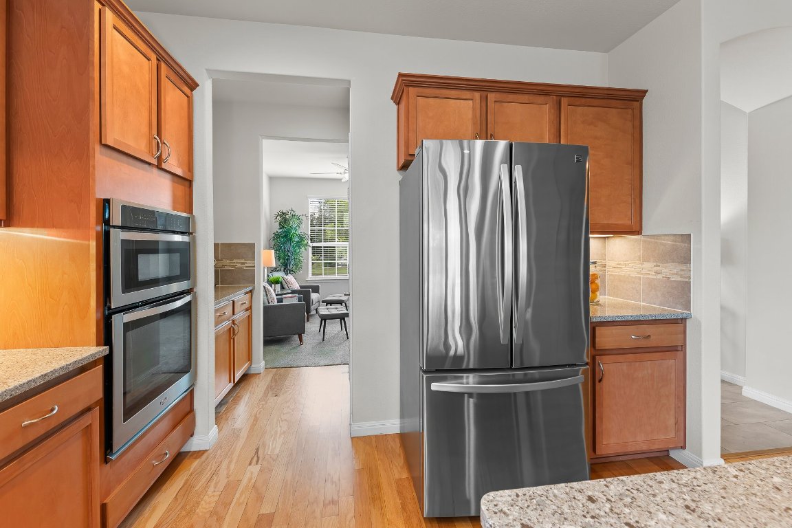 608 Kite Ridge Street Georgetown, TX 78633 - Photo 20 of 39 a kitchen with a refrigerator and a stove top oven