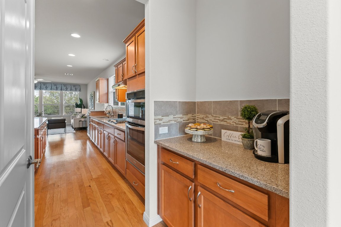 608 Kite Ridge Street Georgetown, TX 78633 - Photo 21 of 39 a kitchen with sink refrigerator and stove