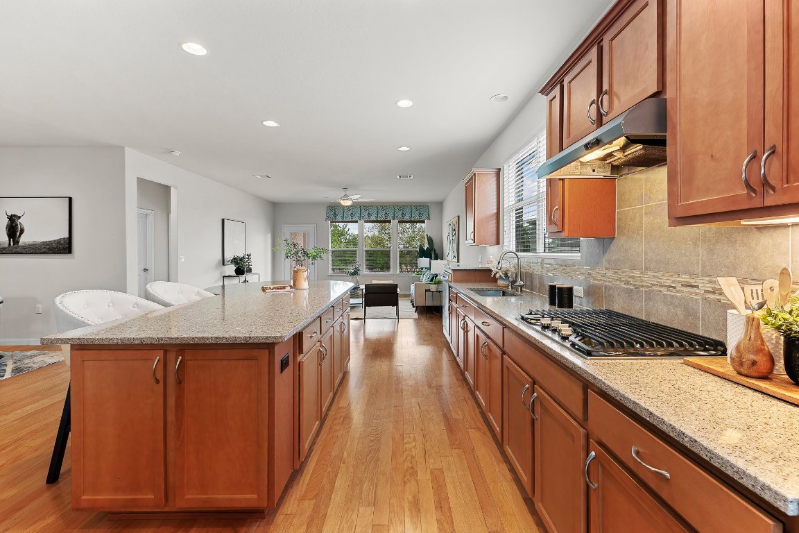 608 Kite Ridge Street Georgetown, TX 78633 - Photo 22 of 39 a kitchen with stainless steel appliances granite countertop a sink stove and cabinets