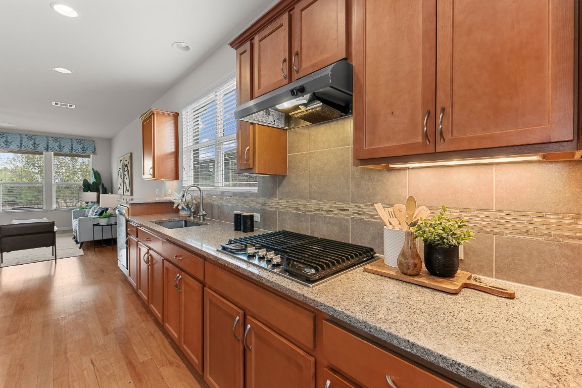 608 Kite Ridge Street Georgetown, TX 78633 - Photo 23 of 39 a kitchen with stainless steel appliances granite countertop a sink stove and cabinets