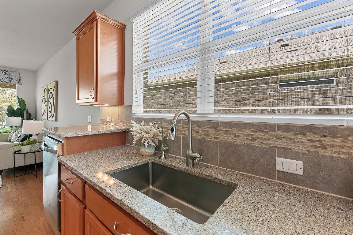 608 Kite Ridge Street Georgetown, TX 78633 - Photo 24 of 39 a kitchen with granite countertop a sink and a stove
