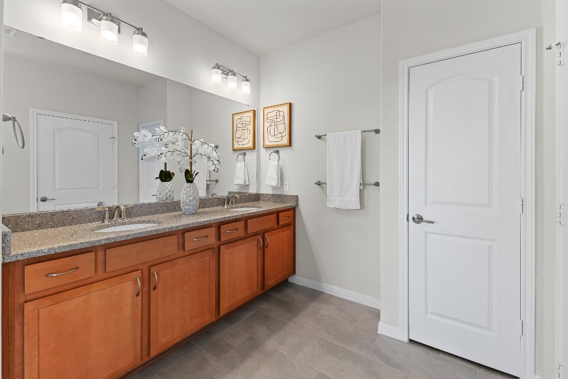 608 Kite Ridge Street Georgetown, TX 78633 - Photo 26 of 39 a bathroom with double sink and a mirror
