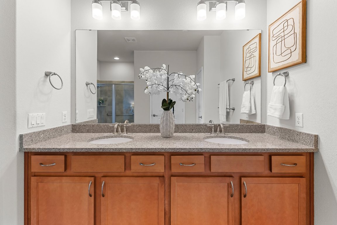 608 Kite Ridge Street Georgetown, TX 78633 - Photo 27 of 39 a bathroom with a granite countertop sink and a mirror